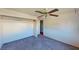 Bedroom with built-in shelving, a ceiling fan and carpeting at 173 Betty Ln, Las Vegas, NV 89110