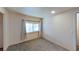 Small carpeted bedroom with bright light from the nearby window at 173 Betty Ln, Las Vegas, NV 89110