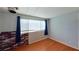 Cozy bedroom with brick accent wall, hardwood floors, and natural light at 173 Betty Ln, Las Vegas, NV 89110