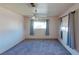Neutral bedroom featuring carpet, a ceiling fan and two windows with curtains at 173 Betty Ln, Las Vegas, NV 89110