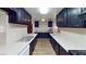 Long kitchen with white counters and black cabinets at 173 Betty Ln, Las Vegas, NV 89110
