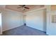 Spacious main bedroom featuring soft carpet, ceiling fan, and tray ceiling at 173 Betty Ln, Las Vegas, NV 89110