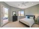 Comfortable bedroom featuring a ceiling fan, large windows, and an outdoor patio at 2 Camino Barcelona Pl, Henderson, NV 89011