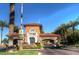 South Shore entrance gate featuring stone archways, tile roof, and desert landscaping at 2 Camino Barcelona Pl, Henderson, NV 89011
