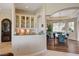 Open-concept dining area with stylish blue chairs and wood floors next to a butlers pantry at 2 Camino Barcelona Pl, Henderson, NV 89011