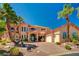Elegant custom home showcasing a circular driveway, lush landscaping, and a grand entrance at 2 Camino Barcelona Pl, Henderson, NV 89011