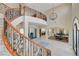 Stunning foyer with a winding staircase, iron detailing, and an open view of the living and dining areas at 2 Camino Barcelona Pl, Henderson, NV 89011