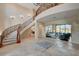 Impressive foyer features a curved staircase, high ceilings, and an open layout connecting to the living spaces at 2 Camino Barcelona Pl, Henderson, NV 89011
