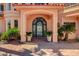 Beautiful arched front door with custom ironwork and manicured landscaping, offering great curb appeal at 2 Camino Barcelona Pl, Henderson, NV 89011