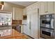 Well-equipped kitchen featuring custom cabinetry, stainless steel appliances, and granite countertops at 2 Camino Barcelona Pl, Henderson, NV 89011