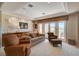 Inviting living room featuring comfortable seating, built-in cabinets, and access to a balcony at 2 Camino Barcelona Pl, Henderson, NV 89011