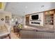 Open-concept living space with a fireplace, built-in shelves, and breakfast bar seating at the kitchen at 2 Camino Barcelona Pl, Henderson, NV 89011
