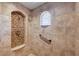 Walk-in shower with a built-in seat, a rain shower head, and safety handrail for accessibility at 2 Camino Barcelona Pl, Henderson, NV 89011