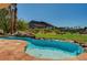 Stunning swimming pool with natural rock features and picturesque views of the golf course and mountains at 2 Camino Barcelona Pl, Henderson, NV 89011