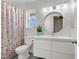 Bright bathroom features a modern vanity, circular mirror, and vibrant shower curtain at 2209 Piccolo Way, Las Vegas, NV 89146