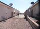 Gravel-covered backyard showcasing ample outdoor space with secure fencing and satellite dishes at 2351 Thornwood Castle Dr, Laughlin, NV 89029