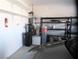 Garage featuring storage shelving, utility access, and a fire extinguisher at 2351 Thornwood Castle Dr, Laughlin, NV 89029