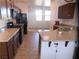 Well-lit kitchen features granite countertops and stainless steel appliances, perfect for cooking and entertaining at 2351 Thornwood Castle Dr, Laughlin, NV 89029
