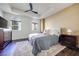 Comfortable bedroom with a tray ceiling, fan, two windows, and stylish decor at 2455 W Serene Ave # 603, Las Vegas, NV 89123