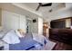 Well-lit bedroom with ceiling fan, closet, and a glimpse into the kitchen at 2455 W Serene Ave # 603, Las Vegas, NV 89123