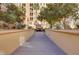Exterior condo grounds feature mature trees along a walkway with access to seating area with a fireplace at 2455 W Serene Ave # 603, Las Vegas, NV 89123
