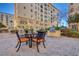 Exterior view of a community grilling area with a table and chairs for outdoor dining at 2455 W Serene Ave # 603, Las Vegas, NV 89123