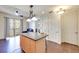 Open kitchen with granite island, stainless appliances, and view to living area with balcony access at 2455 W Serene Ave # 603, Las Vegas, NV 89123