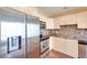 Bright kitchen features stainless steel appliances, tile backsplash and light colored wood cabinets at 2455 W Serene Ave # 603, Las Vegas, NV 89123