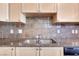 Bright kitchen features granite countertops, stainless sink and decorative tile backsplash at 2455 W Serene Ave # 603, Las Vegas, NV 89123