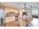 Modern kitchen featuring stainless steel appliances, granite countertops, tile backsplash, and adjacent living area at 2455 W Serene Ave # 603, Las Vegas, NV 89123