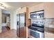 Kitchen features stainless appliances, tile backsplash, and tile floor, with bathroom visible in background at 2455 W Serene Ave # 603, Las Vegas, NV 89123