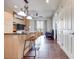 Modern kitchen island with seating and stainless appliances, with a view of the living area and balcony at 2455 W Serene Ave # 603, Las Vegas, NV 89123