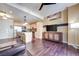 Open concept living room with island kitchen, wood floors, and view of entertainment center at 2455 W Serene Ave # 603, Las Vegas, NV 89123