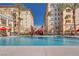 Community pool with palm trees, lounge chairs, and clear blue water for relaxing by the pool at 2455 W Serene Ave # 603, Las Vegas, NV 89123