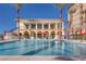 Resort-style pool with palm trees and lounge chairs offers a relaxing outdoor experience for residents at 2455 W Serene Ave # 603, Las Vegas, NV 89123