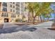 Walkway with mature trees, lush landscaping, and lighting for evening strolls through community at 2455 W Serene Ave # 603, Las Vegas, NV 89123