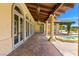 Expansive covered patio with travertine flooring, columns, and pool views, perfect for outdoor entertaining at 2600 Cervino Cir, Henderson, NV 89052