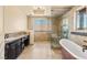 Elegant bathroom showcasing walk-in shower, soaking tub, and custom vanity at 2600 Cervino Cir, Henderson, NV 89052