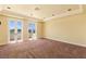 Bright bedroom with plush carpet, double french doors, and balcony access at 2600 Cervino Cir, Henderson, NV 89052