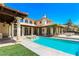 Resort-style backyard featuring a sparkling pool, elegant patio, and lush landscaping for ultimate relaxation at 2600 Cervino Cir, Henderson, NV 89052
