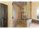 Luxurious walk-in shower with frameless glass enclosure and mosaic tile detailing at 2600 Cervino Cir, Henderson, NV 89052