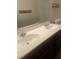 Bathroom with double sinks and a large mirror at 2667 Aracatuba Ave, Las Vegas, NV 89121