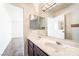 Bathroom with dual sinks, large mirror, and a connecting door to another room at 2667 Aracatuba Ave, Las Vegas, NV 89121