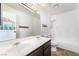Bathroom with a double sink vanity, large mirror, and a tub with a shower at 2667 Aracatuba Ave, Las Vegas, NV 89121