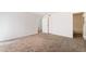 Spacious bedroom featuring neutral carpet, white walls, and an open closet space at 2667 Aracatuba Ave, Las Vegas, NV 89121