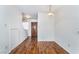 Dining area featuring pristine white walls, hardwood flooring, and a door leading to stairs at 2667 Aracatuba Ave, Las Vegas, NV 89121