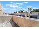 Overhead view shows a row of townhomes with attached garages and palm trees on a partly cloudy day at 2667 Aracatuba Ave, Las Vegas, NV 89121