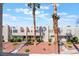 Townhomes with xeriscaped front yards, palm trees and sidewalks on a partly cloudy day at 2667 Aracatuba Ave, Las Vegas, NV 89121