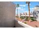 Balcony view of townhomes surrounded by xeriscaped yards featuring palm trees and other greenery at 2667 Aracatuba Ave, Las Vegas, NV 89121