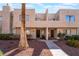 Inviting townhouse showcasing a well-maintained exterior and vibrant landscaping with lush plants at 2667 Aracatuba Ave, Las Vegas, NV 89121